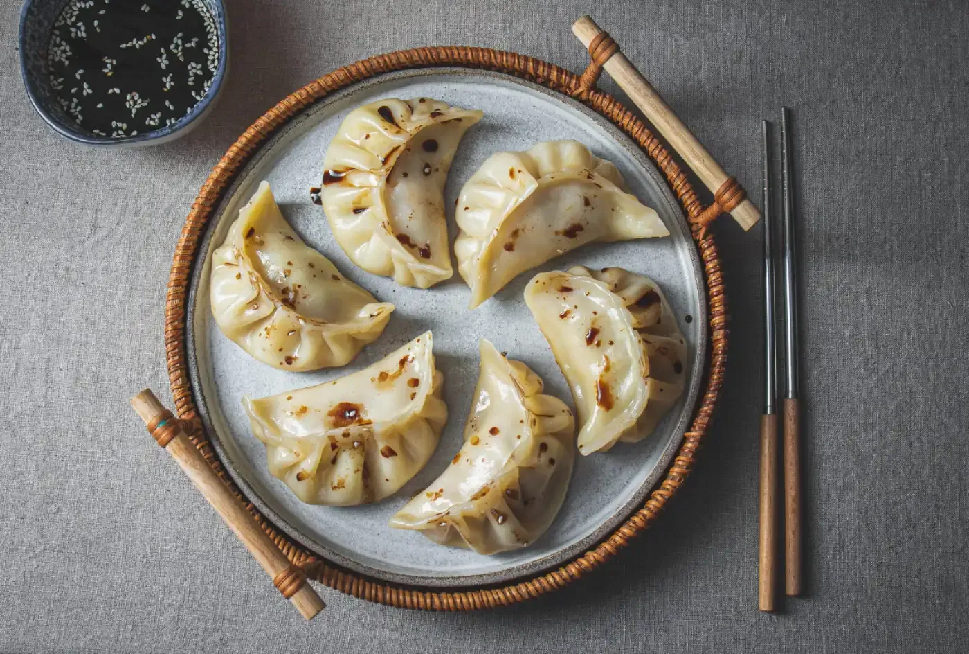 Dumplings on plate wtith chopsticks
